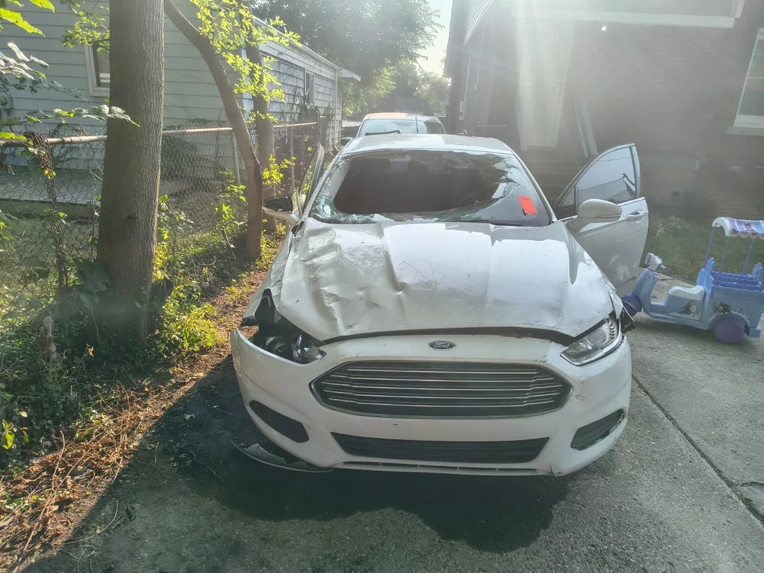 Ford Fusion with collision damage awaiting windshield replacement